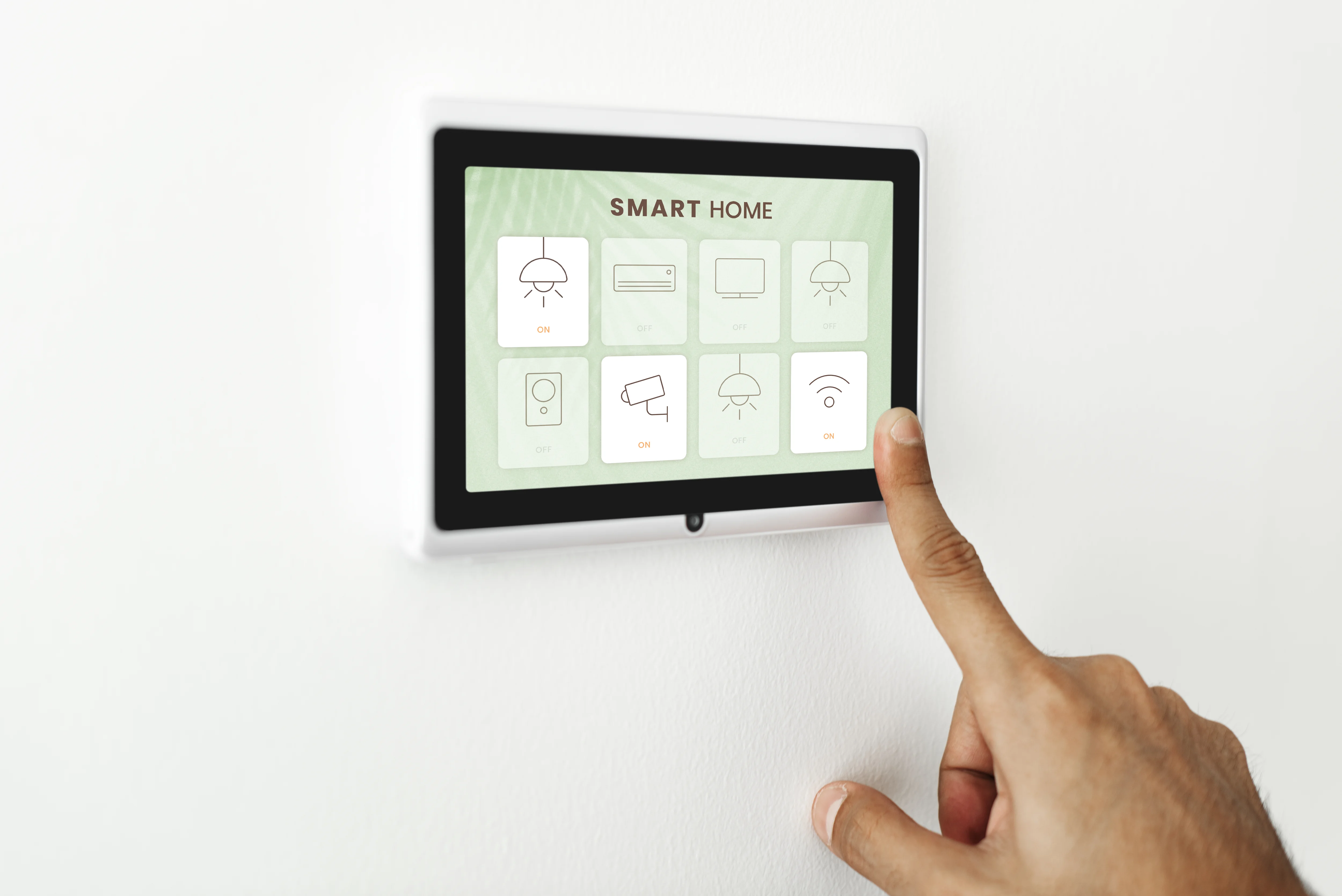 A person using the tablet on the wall, tapping on a screen that displays a “SMART HOME” control panel.